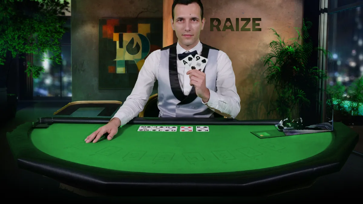A RAIZE dealer in waistcoat and bow tie at a green-felt table, holding two cards above a five-card board